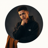 Circular portrait of a young man, Leo Mandella, wearing a GRAFFIX streetwear essential with a confident expression against a 