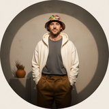Circular portrait of Magnus Ronning, a stylish man, against a clean, muted background.